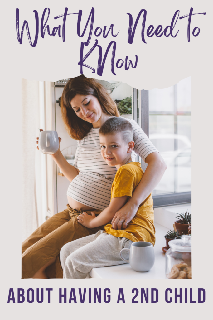Pregnant woman sitting on counter with child