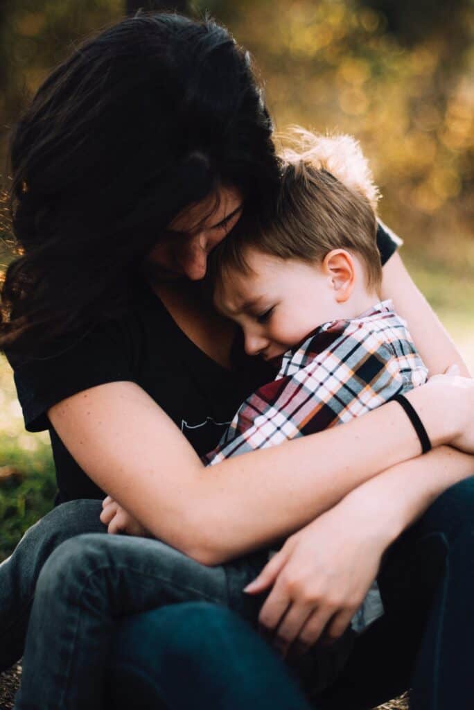 woman holding crying boy